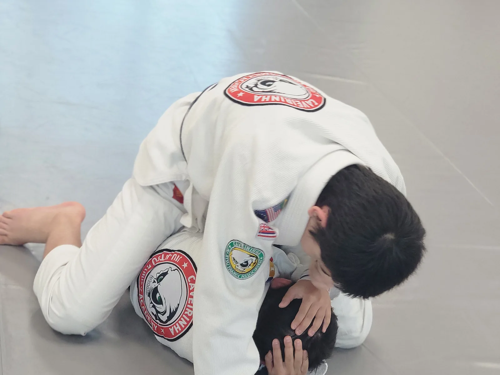 Young CJJF student grappling in CJJF-branded Gi