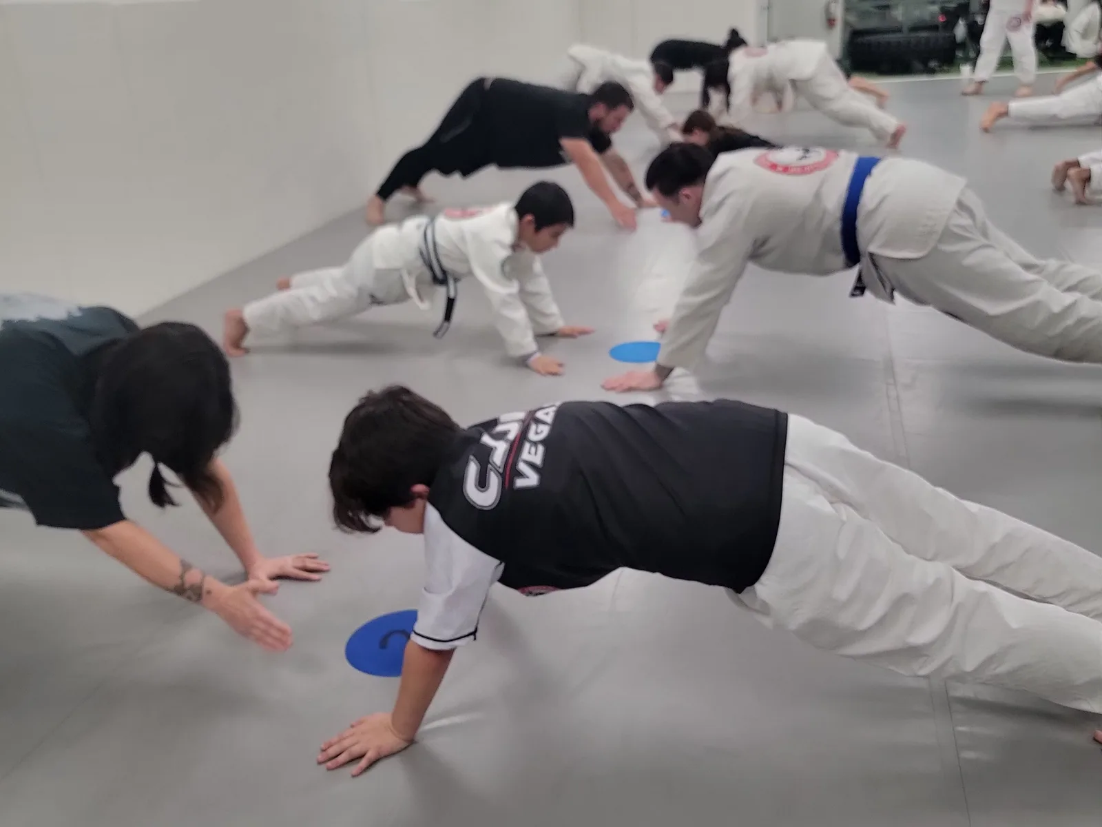 CJJF kids conditioning — push-ups on the mat