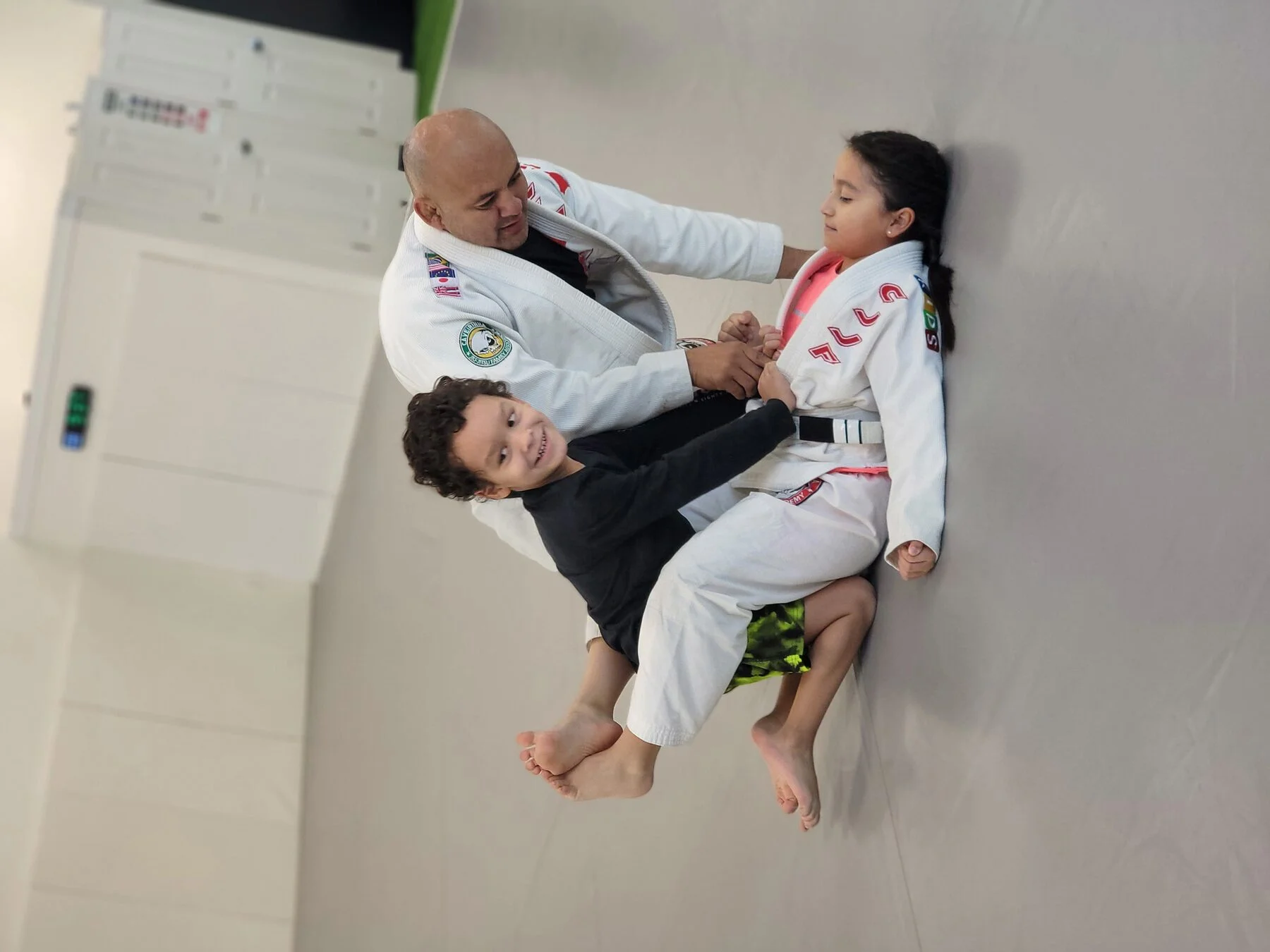 Kids in CJJF-branded Gi — showing the Caveirinha patches