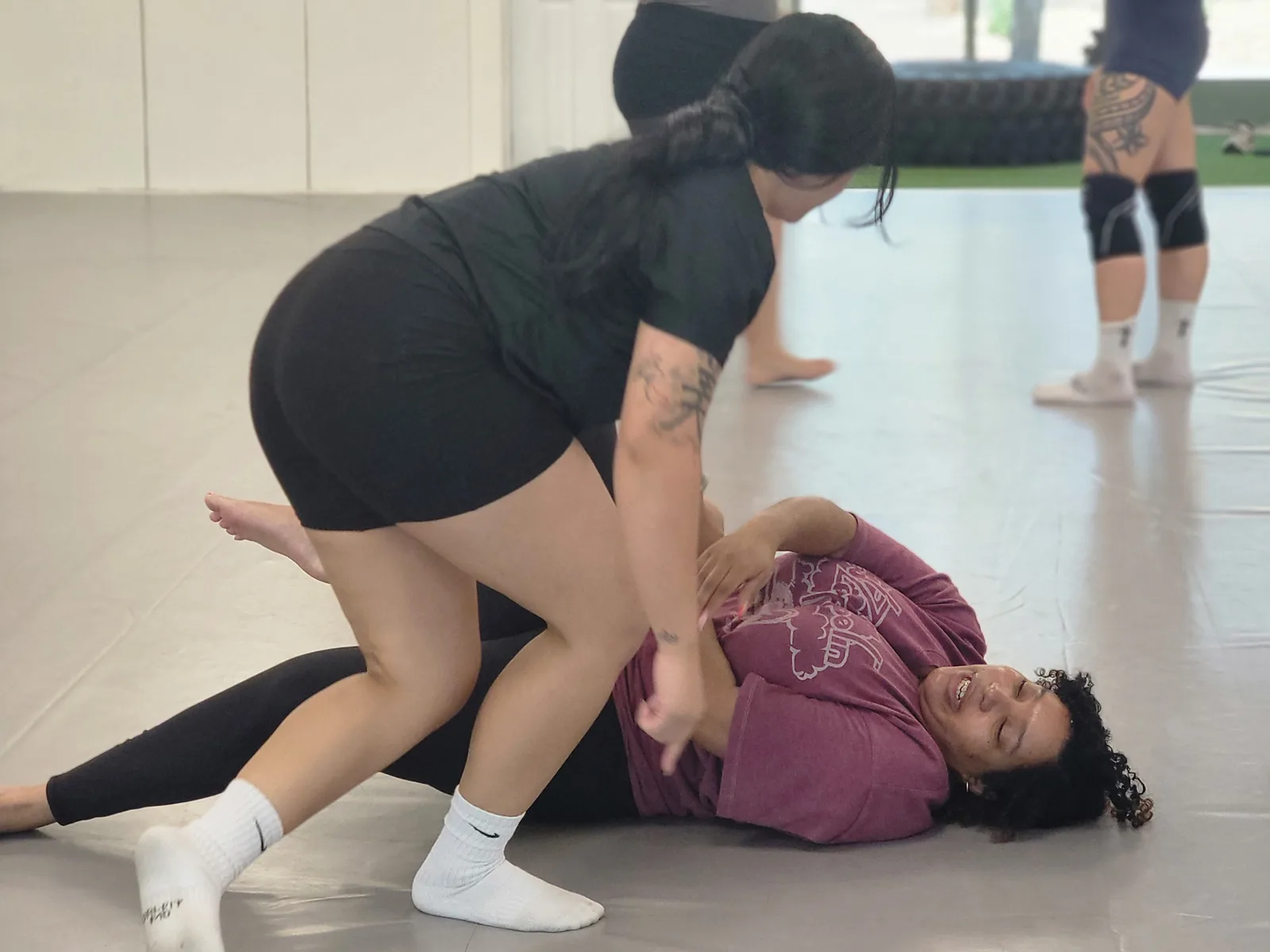 Woman rolling at CJJF Women's BJJ class